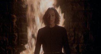 Movie still from “Inferno” (1980), directed by Dario Argento – A woman standing in front of a fire tunnel; Medium shot, Low angle