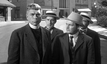 Movie still from “Inherit the Wind” (1960), directed by Stanley Kramer – A black and white photo of a group of men in suits and hats; Medium shot, Low angle