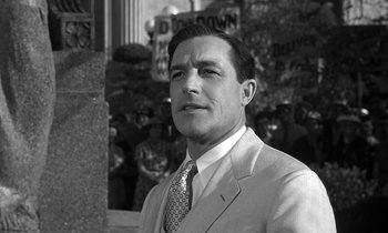 Movie still from “Inherit the Wind” (1960), directed by Stanley Kramer – Black and white photograph of a man wearing a suit and tie; Close Up shot, Low angle