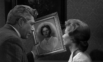 Movie still from “Inherit the Wind” (1960), directed by Stanley Kramer – A man and a woman looking at a picture of a woman; Close Up shot, Over the shoulder angle