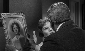 Movie still from “Inherit the Wind” (1960), directed by Stanley Kramer – An older man and woman looking at an old picture; Close Up shot, Over the shoulder angle