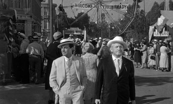 Movie still from “Inherit the Wind” (1960), directed by Stanley Kramer – A black - and - white photo of two men in suits and hats; Wide shot, Low angle