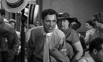 Movie still from “Inherit the Wind” (1960), directed by Stanley Kramer – An old photo of a man and a woman; Medium shot, Over the shoulder angle