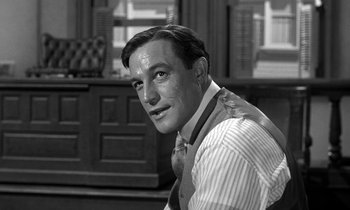 Movie still from “Inherit the Wind” (1960), directed by Stanley Kramer – A man in a striped dress shirt and tie; Close Up shot, Over the shoulder angle