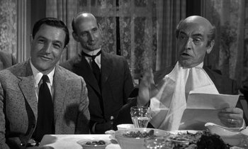 Movie still from “Inherit the Wind” (1960), directed by Stanley Kramer – A group of men sitting at a dinner table; Medium shot, Over the shoulder angle