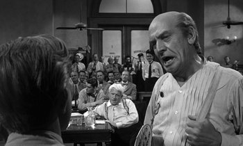 Movie still from “Inherit the Wind” (1960), directed by Stanley Kramer – An older man in front of a crowd of people; Medium shot, Over the shoulder angle