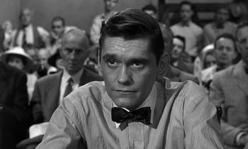 Movie still from “Inherit the Wind” (1960), directed by Stanley Kramer – A black and white photo of a man with a bow tie; Close Up shot, Over the shoulder angle