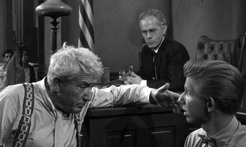 Movie still from “Inherit the Wind” (1960), directed by Stanley Kramer – Two men and a woman in a court room; Medium shot, Over the shoulder angle