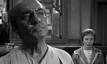 Movie still from “Inherit the Wind” (1960), directed by Stanley Kramer – An older man and a young woman standing next to each other in front of a building; Close Up shot, Low angle