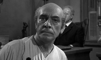 Movie still from “Inherit the Wind” (1960), directed by Stanley Kramer – An older man in a courtroom with a judge in the background; Close Up shot, Low angle