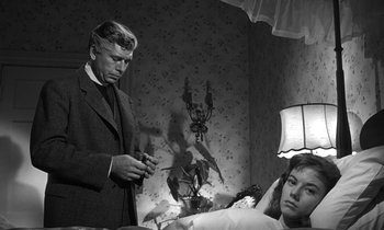 Movie still from “Inherit the Wind” (1960), directed by Stanley Kramer – An old photo of a man looking at a woman in bed; Medium shot, Over the shoulder angle