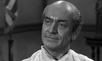 Movie still from “Inherit the Wind” (1960), directed by Stanley Kramer – An older man with a shaved head looks to his left; Close Up shot, Low angle