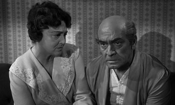 Movie still from “Inherit the Wind” (1960), directed by Stanley Kramer – An older man and a younger woman looking at each other; Medium shot, High angle