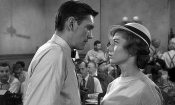 Movie still from “Inherit the Wind” (1960), directed by Stanley Kramer – A man and a woman face to face in a courtroom; Close Up shot, Over the shoulder angle