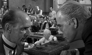 Movie still from “Inherit the Wind” (1960), directed by Stanley Kramer – Two men face each other in front of an audience; Close Up shot, Over the shoulder angle