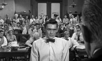 Movie still from “Inherit the Wind” (1960), directed by Stanley Kramer – A man standing in front of a group of people; Medium shot, Over the shoulder angle