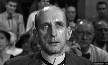 Movie still from “Inherit the Wind” (1960), directed by Stanley Kramer – A man with a bald head and a tie; Close Up shot, Low angle