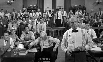 Movie still from “Inherit the Wind” (1960), directed by Stanley Kramer – A group of men sitting in front of each other in a room; Wide shot, High angle