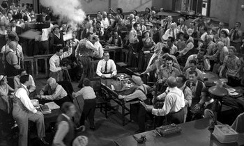 Movie still from “Inherit the Wind” (1960), directed by Stanley Kramer – A group of men sitting around a table in a room; Wide shot, High angle