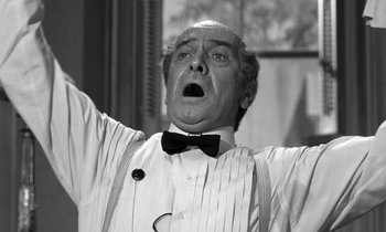 Movie still from “Inherit the Wind” (1960), directed by Stanley Kramer – An older man in a white shirt and a bow tie; Close Up shot, Low angle