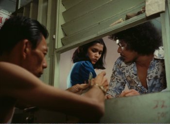 A group of people standing next to each other in a room