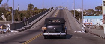 Movie still from “Inside Daisy Clover” (1965), directed by Robert Mulligan – An old car is driving down the street; Wide shot, High angle