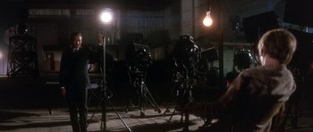 Movie still from “Inside Daisy Clover” (1965), directed by Robert Mulligan – A group of cameras sitting on top of a wooden floor; Wide shot, Low angle