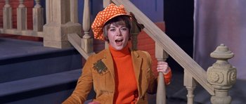 Movie still from “Inside Daisy Clover” (1965), directed by Robert Mulligan – A woman wearing a hat and orange jacket; Medium shot, Low angle