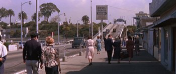 Movie still from “Inside Daisy Clover” (1965), directed by Robert Mulligan – A group of people walking across a bridge; Wide shot, High angle