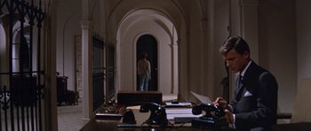 Movie still from “Inside Daisy Clover” (1965), directed by Robert Mulligan – A person standing in a room with a door open; Wide shot, High angle