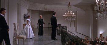 Movie still from “Inside Daisy Clover” (1965), directed by Robert Mulligan – A man and a woman standing in front of chandeliers; Wide shot, Low angle