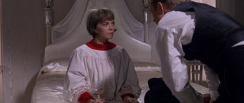 Movie still from “Inside Daisy Clover” (1965), directed by Robert Mulligan – A woman sitting on the ground holding a wine glass; Medium shot, High angle