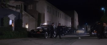 Movie still from “Inside Daisy Clover” (1965), directed by Robert Mulligan – A couple of men walking down a street next to old cars; Extreme Wide shot, High angle