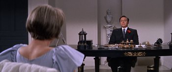 Movie still from “Inside Daisy Clover” (1965), directed by Robert Mulligan – A man sitting at a dinner table with a woman; Medium shot, Over the shoulder angle