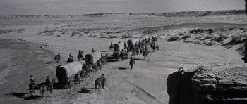 Movie still from “Inside Daisy Clover” (1965), directed by Robert Mulligan – A black and white photo of a group of people on horses; Extreme Wide shot, High angle