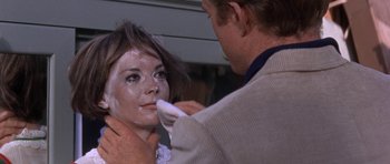 Movie still from “Inside Daisy Clover” (1965), directed by Robert Mulligan – A man is putting makeup on a woman's face; Close Up shot, Over the shoulder angle
