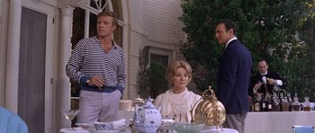 Movie still from “Inside Daisy Clover” (1965), directed by Robert Mulligan – A man and a woman sitting at a dining table; Medium shot, Low angle