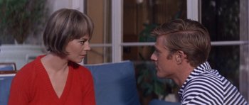 Movie still from “Inside Daisy Clover” (1965), directed by Robert Mulligan – A man and a woman sitting on a couch talking to each other; Close Up shot, Over the shoulder angle