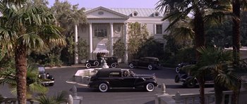 Movie still from “Inside Daisy Clover” (1965), directed by Robert Mulligan – A couple of cars parked in front of a large building; Extreme Wide shot, High angle