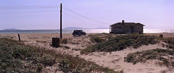 Movie still from “Inside Daisy Clover” (1965), directed by Robert Mulligan – A truck driving down a dirt road next to the ocean; Extreme Wide shot, High angle