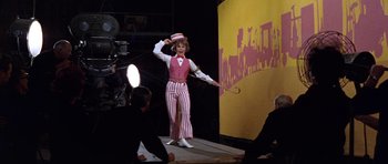 Movie still from “Inside Daisy Clover” (1965), directed by Robert Mulligan – A man dressed as a circus ringmaster on a stage; Medium shot, Low angle