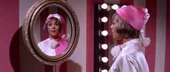Movie still from “Inside Daisy Clover” (1965), directed by Robert Mulligan – A woman is looking in the mirror in front of a mirror; Close Up shot, Low angle