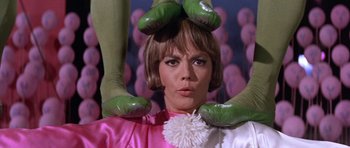 Movie still from “Inside Daisy Clover” (1965), directed by Robert Mulligan – A woman in a pink dress with green gloves on her head; Close Up shot, Low angle