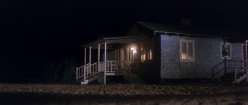 Movie still from “Inside Daisy Clover” (1965), directed by Robert Mulligan – A house that is lit up at night time; Extreme Wide shot, Low angle