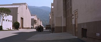Movie still from “Inside Daisy Clover” (1965), directed by Robert Mulligan – Two people are walking down a street in a city; Extreme Wide shot, High angle