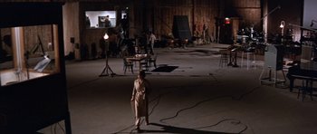 Movie still from “Inside Daisy Clover” (1965), directed by Robert Mulligan – A woman in a dress standing in an empty room; Extreme Wide shot, High angle