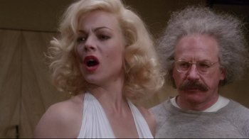 Movie still from “Insignificance” (1985), directed by Nicolas Roeg – A man and a woman are standing next to each other; Close Up shot, Low angle