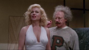 Movie still from “Insignificance” (1985), directed by Nicolas Roeg – A man and a woman standing next to each other; Medium shot, Low angle