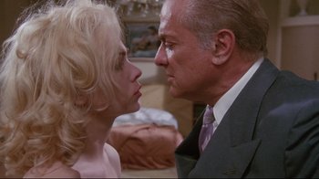 Movie still from “Insignificance” (1985), directed by Nicolas Roeg – A man and a woman face to face in front of a bed; Close Up shot, Low angle