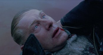 Movie still from “Insomnia” (1997), directed by Erik Skjoldbjærg – An old man laying on the ground with blood on his face; Close Up shot, Overhead angle